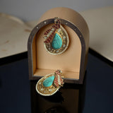 Teardrop statement studs with peacock motif