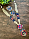 Long pendant set on seed pearls with matching studs