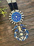 Long pendant set on seed pearls with matching studs