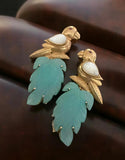 Copper Base Parrot Motif earrings with carved leaf design