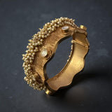 Thick bracelet with silver foil accents and pearls border