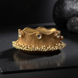 Thick bracelet with silver foil accents and pearls border