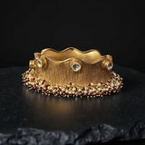 Thick bracelet with silver foil accents and pearls border